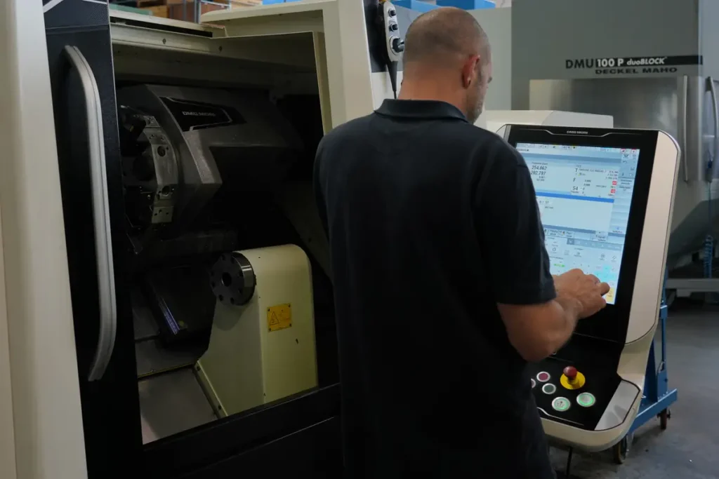 Operatore programma un centro di lavoro a controllo numerico